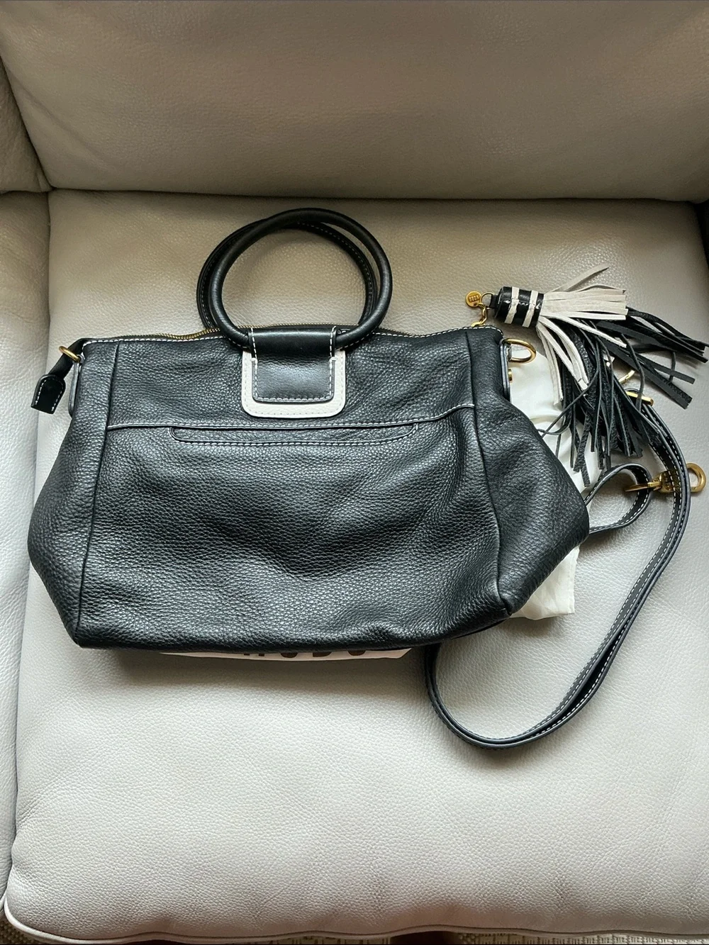 HOBO Sheila Black Pebbled Leather Top-Handle Hobo with Gold Hardware and tassel.